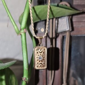 Gold Pendant Necklace with Sun and Moon Design